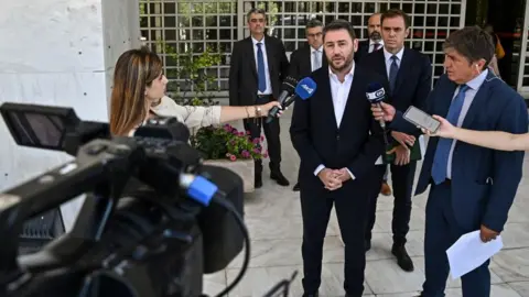 Getty Images Nikos Androulakis, a member of European Parliament and president of the Movement for Change (Pasok-Kinal) party, talks to media after filing a complaint at the Supreme Court in Athens on 26 July