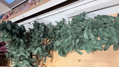 Voluntary Norfolk A dismantled Christmas tree which has been vandalised and is lying on its side on the floor.