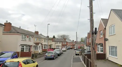 Google A residential street with houses and cars along both sides