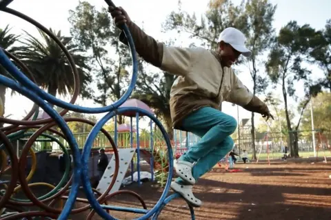 EPA A young migrant plays at the sports stadium where he has sought shelter in Mexico City