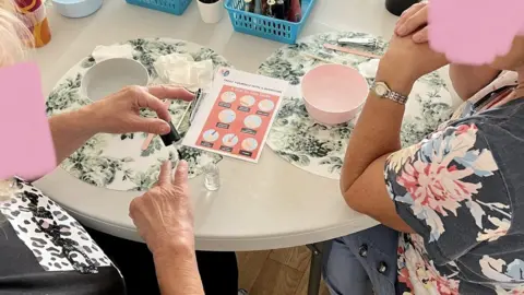 Natacha Sullivan Women taking part in a manicure workshop