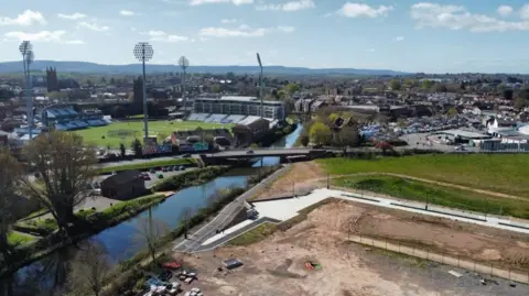 Chris Haig A drone image of the end of the boulevard, which is surrounged by empty and. The boulevard reaches the River Tone and a bridge to the local cricket ground. 