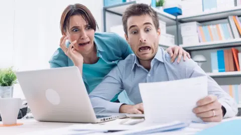 Getty Images Panicking couple in office