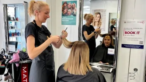 Humber and North Yorkshire Cancer Alliance Hairdresser talking to client in Hull