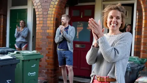 Getty Images Annemarie Plas with others taking part in clap for carers