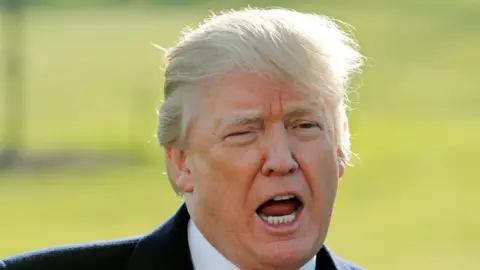 Reuters President Trump photographed outdoors in mid-sentence