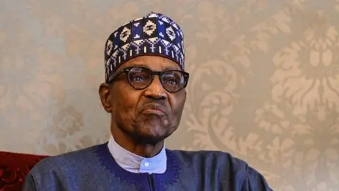 Former Nigeria president Muhammadu Buhari with wearing eye glasses and a traditional hat
