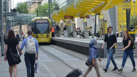 people at Exchange Square tram stop