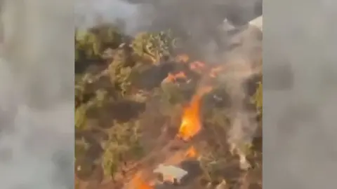 A screengrab showing flames in a forested area of Kogi state in Nigeria.