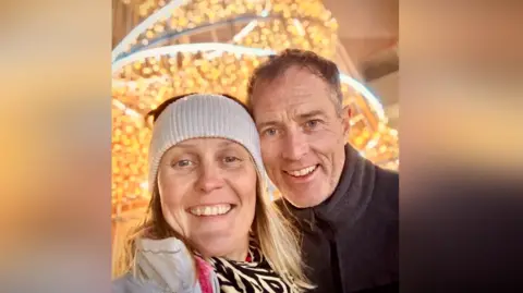 Family handout Craig and Lindsay Foreman take a selfie in front of some Christmas lights