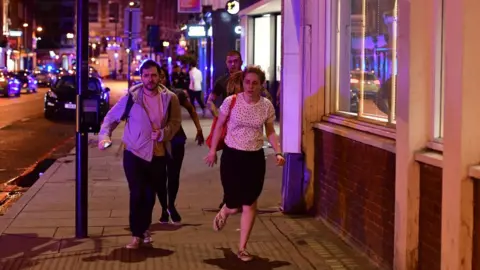 PA People run down Borough High Street as police are dealing with a "major incident" at London Bridge