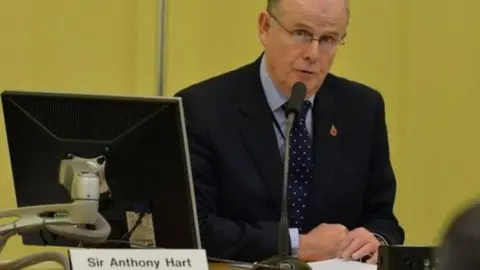 PAcemaker  Sir Anthony Hart sits at a desk