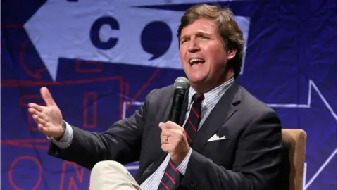 Getty Images Tucker Carlson speaks onstage during Politicon 2018 at Los Angeles Convention Center