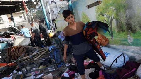 A boy in the rubble after airstrike 