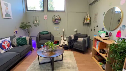 Andy's Room has sofas, armchairs and a variety of different sensory features, including a guitar.