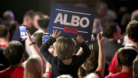 Getty Images A young supporter holds a sign at the Labor Party election night event in Sydney, Australia, on Saturday, May 3