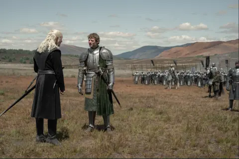 Theo Whiteman/HBO Two men square up for a sword fight 