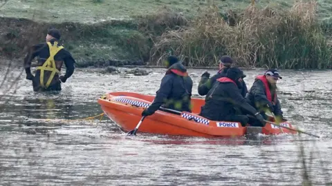 PA Media Police break the ice on the lake at Babbs Mill Park in Kingshurst