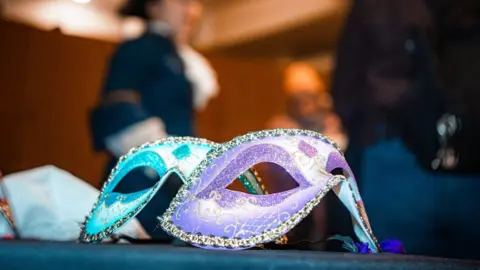 Josh Heeley/Royal Armouries A blue and a purple eye mask decorated in gold on a table