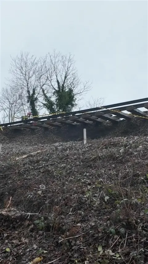 A view of the track dangling, where no land is supported it after a landslip.