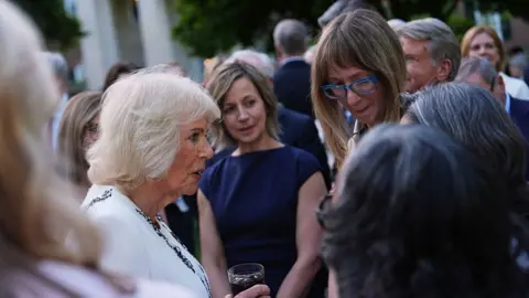 Getty Images Queen Camilla greets guests during a garden party at the British Embassy in Washington DC.