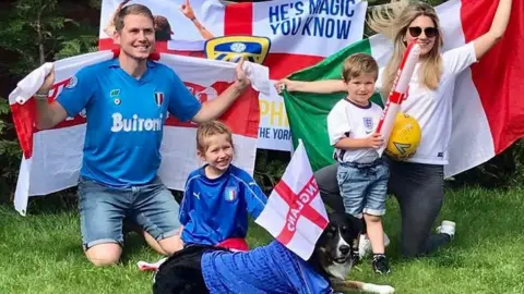 Family photo Daniel and Carlotta Furniss waving flags