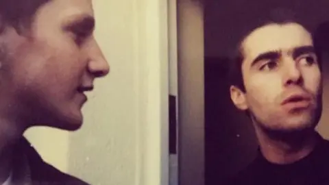 Anthony Lanni, pictured when he was aged 15 in 1996, standing next to Liam Gallagher in the front door of the musician's home
