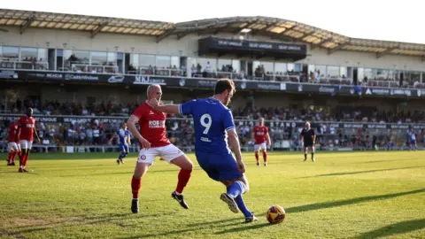 Bristol Rovers FC Former Bristol Rovers player Rickie Lambert prepares to cross the ball during a charity match between legends from Rovers and Bristol City in aid of charity