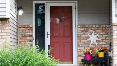 Reuters Bullet holes mark the front door of the Hoffman home