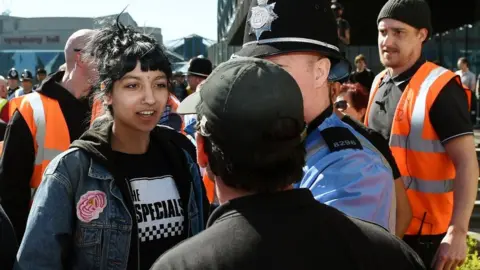 PA Saffiyah Khan in a stand-off in her Specials T-shirt with the EDL's Ian Crossland, during the protest in 2017 in Birmingham