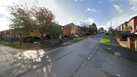 Manor Oaks Place, at the junction with Outram Road