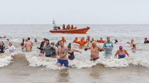 Chris Taylor Swimmers taking to the sea at Sheringham, Norfolk, to raise money for the lifeboat service