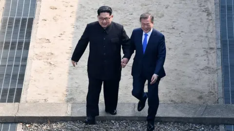 Getty Images Kim Jong-un and Moon Jae-in walk in the DMZ