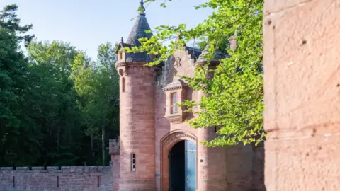 Knight Frank The entrance to the castle with a large arched gateway and turret