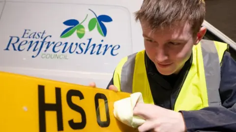 Mark Gibson Council Trainee cleans number plate