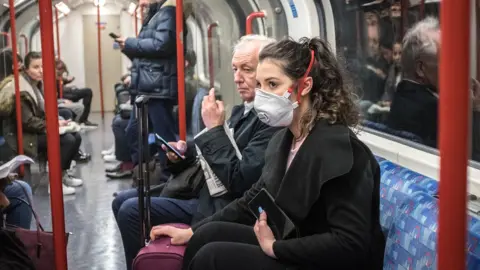 Getty Images A woman in a mask on the London Underground