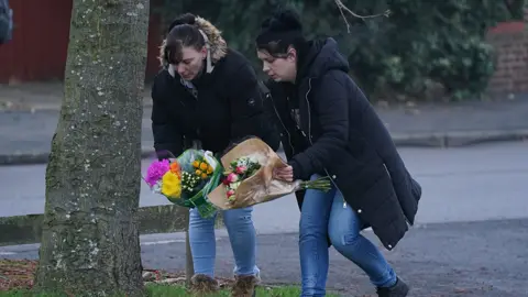 PA Media Flowers being placed at tree