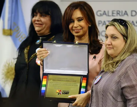 Getty Images Cristina Fernandez de Kirchner holds a plaque given by members of the Argentine Federation of Lesbians, Gays, Bisexuals and Transvestites