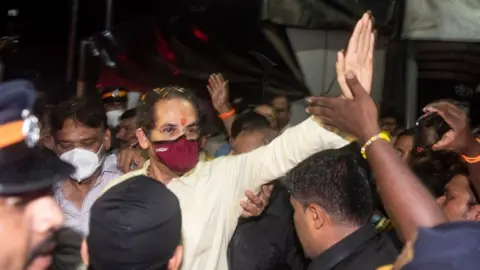 Getty Images Maharashtra CM Uddhav Thackeray greets hundreds of Shiv Sena supportes gathered outside Matoshree, his personal residence in Bandra after leaving from Varsha, the Chief Minister's official residence on June 22, 2022 in Mumbai, India.