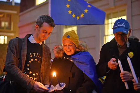 Dominic Lipinski/PA Wire Pro-EU supporters light candles in Smith Square in Westminster, London, ahead of the UK leaving the European Union at 11pm on Friday.