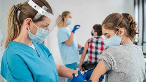 Getty Images Girl getting a jab