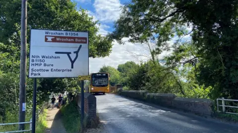 LDRS Bus approaching humpback bridge in village of Coltishall