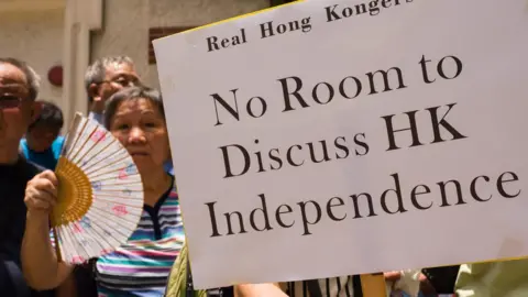 AFP Protesters holding a banner 'Nor room to discuss HK independence'