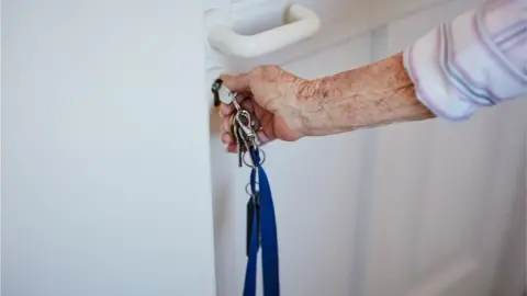 Getty Images Woman opening door