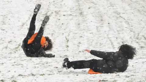 PA Wire People sledging in Greenwich, south-east London