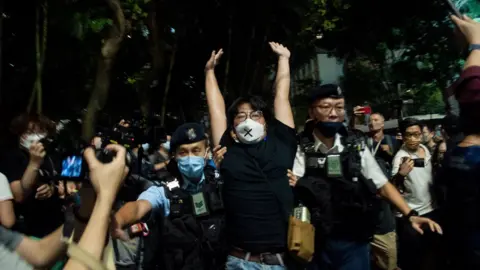 AFP An activist is arrested in Hong Kong on Saturday