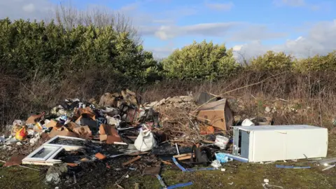 PA Media Fly-tipping in Ashford, Kent, 2019 (file image)