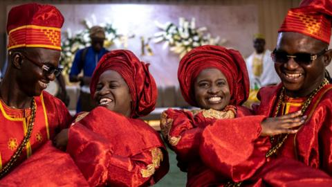 Twin brothers and sisters pose for a photo at the wedding
