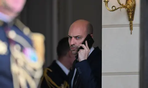 AFP via Getty Images Jean Noel Barrot, Minister for Europe and Foreign Affairs, on the phone during at the Elysee Palace in Paris, France, April 2026. 