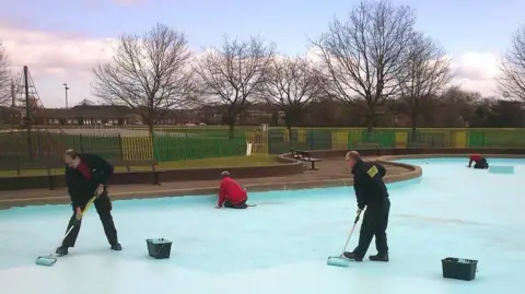 Nottingham City Council Men with rollers paint the pool